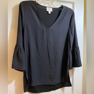 Julie Brown black blouse with bell sleeves.